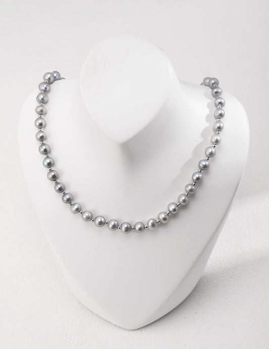 Enhance your style with a grey freshwater pearl necklace showcased on a white mannequin, exuding timeless beauty.