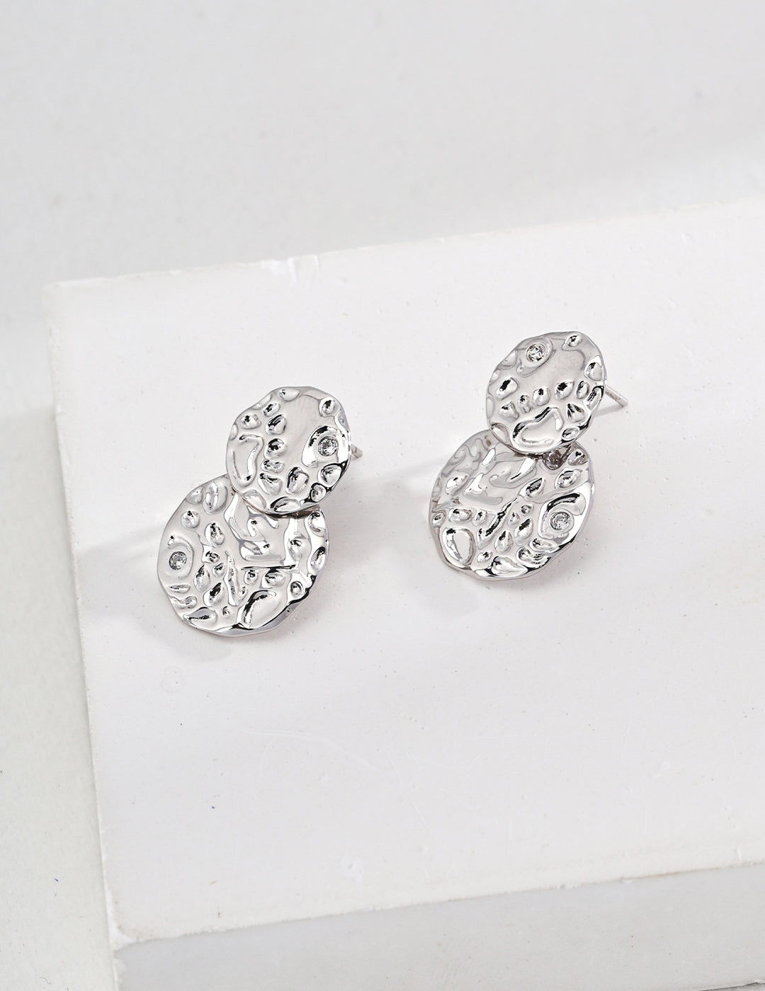 Intricately designed silver sculptured statement earrings.