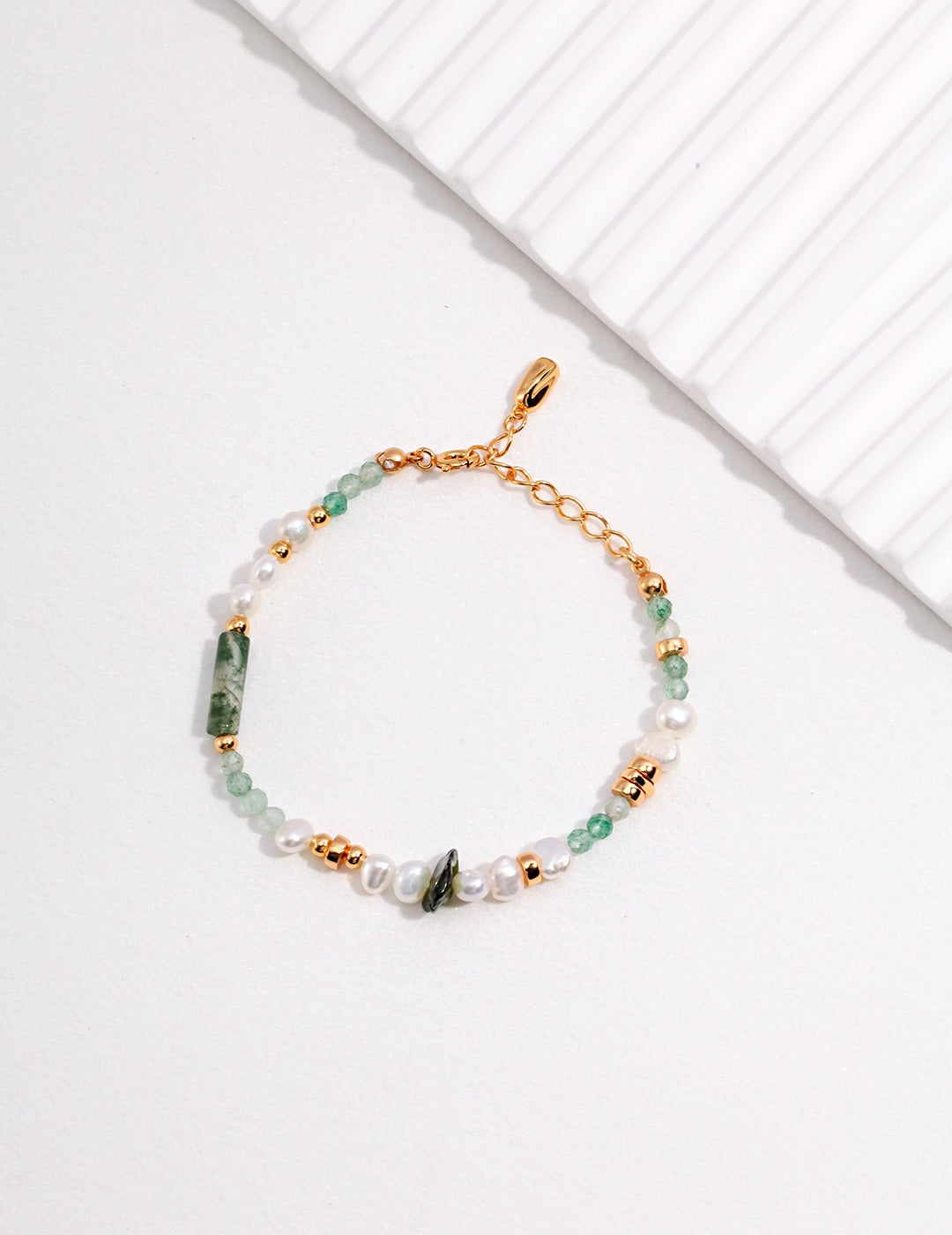 Elegant accessory with vibrant green and shimmering gold beads.