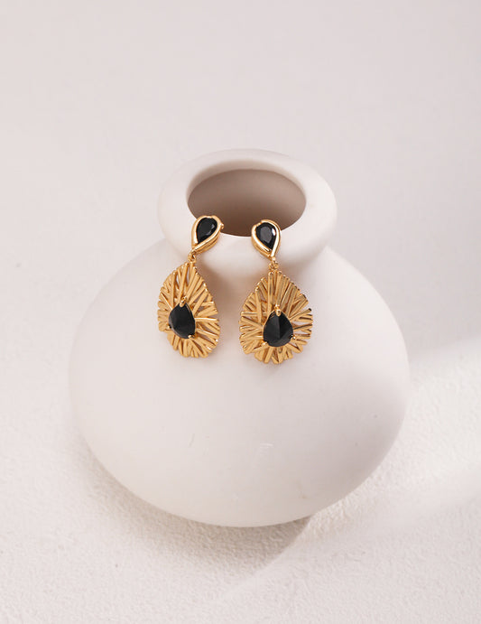 Exquisite carbonado gold plated earrings, radiating an aura of magic and mystery.