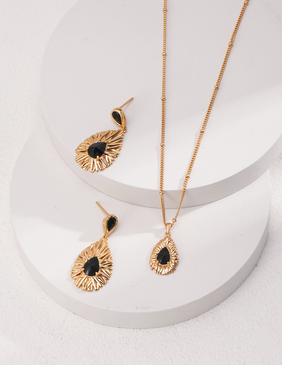 Shimmering gold plated necklace and earrings with a touch of magic and mystery.