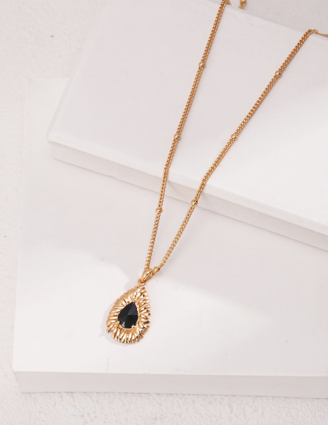 Gold plated necklace with black carbonado diamond pendant.