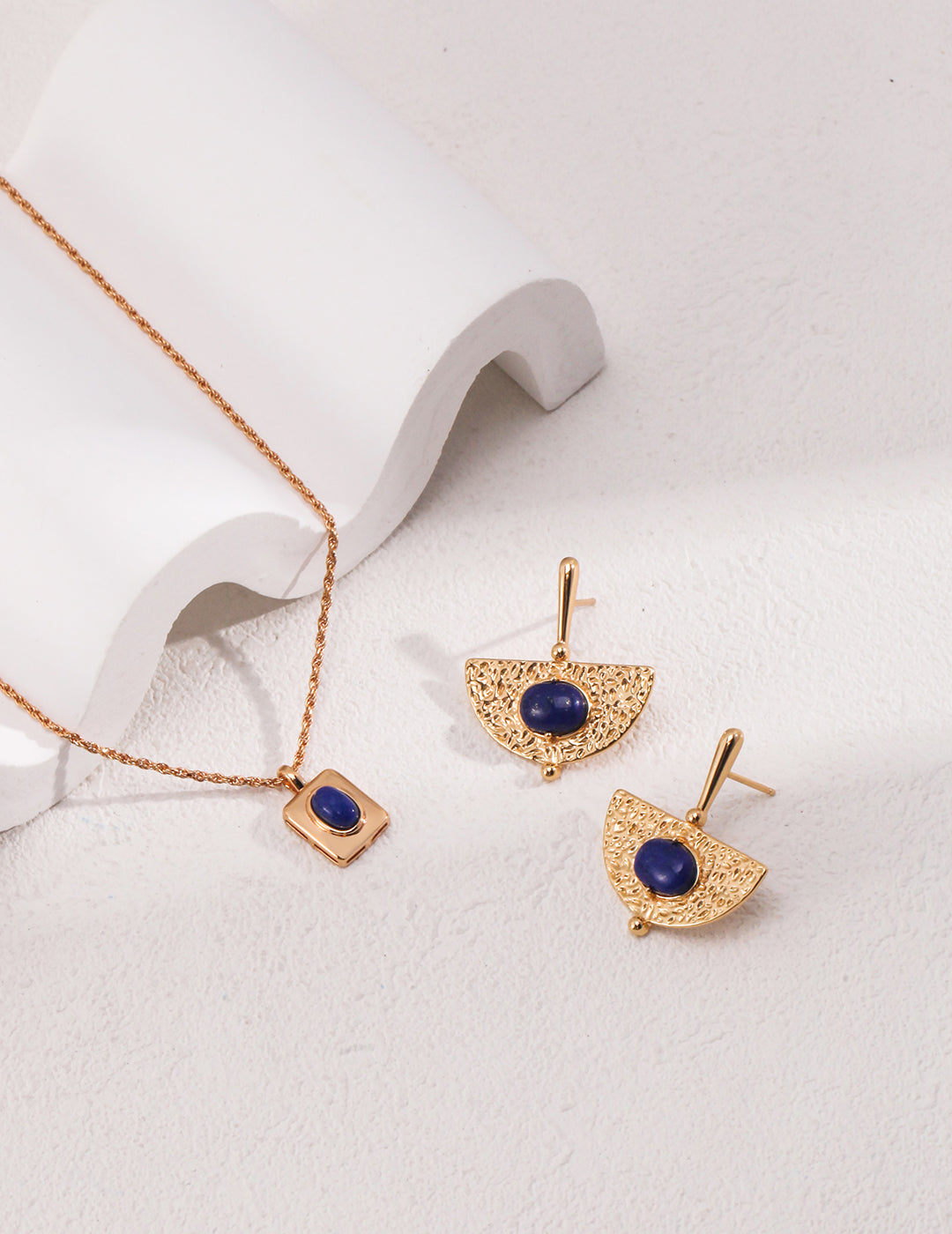 Stunning gold necklace and earrings with blue lapis lazuli.