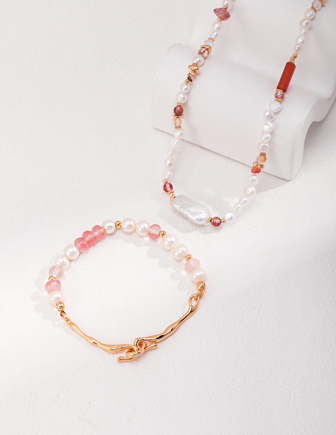 Freshwater pearl necklace and bracelet set with coral beads and strawberry quartz, elegant and stylish accessories.