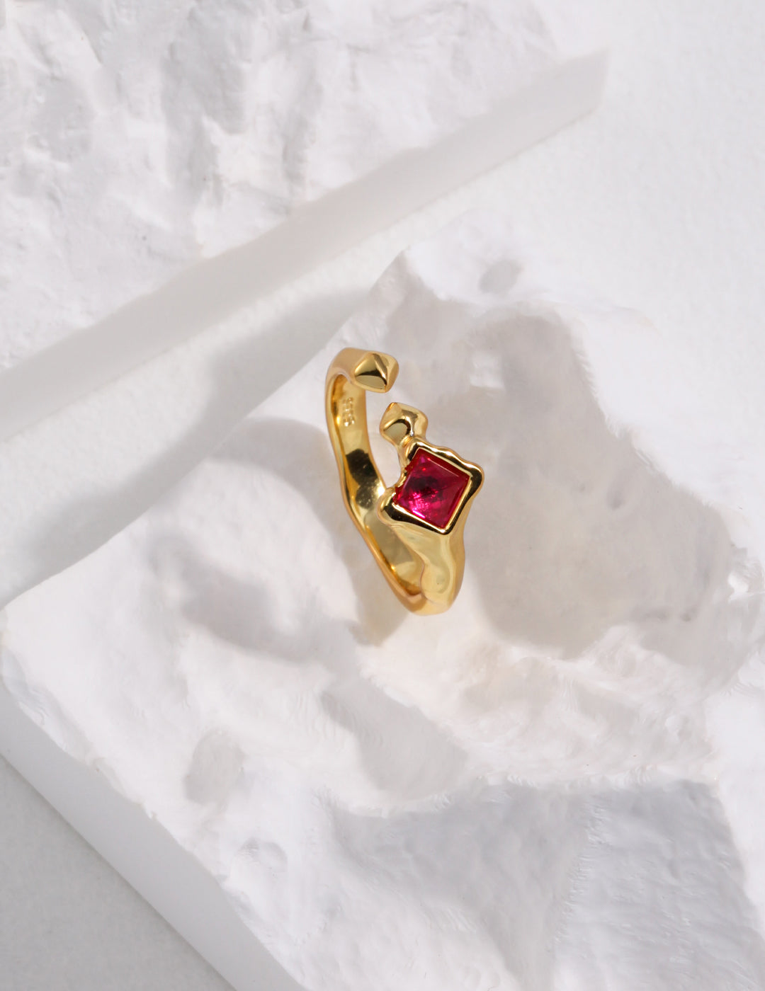 An exquisite gold ring adorned with a lab-created ruby stone, epitomizing sophistication.