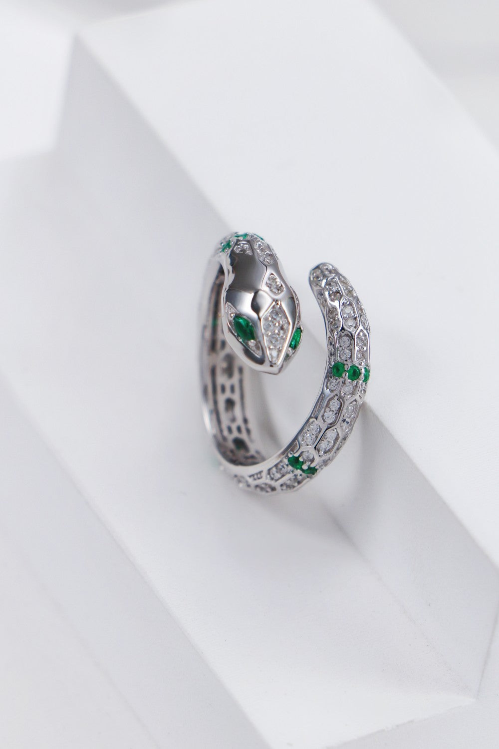 A striking silver snake ring, beautifully crafted and enhanced by the brilliance of cubic zirconia.