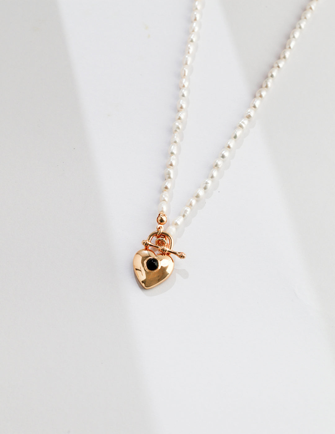 Delicate rice pearl necklace with gold plated heart pendant