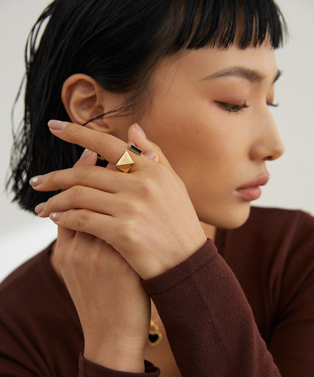 Woman with gold enamel ring posing as a model.