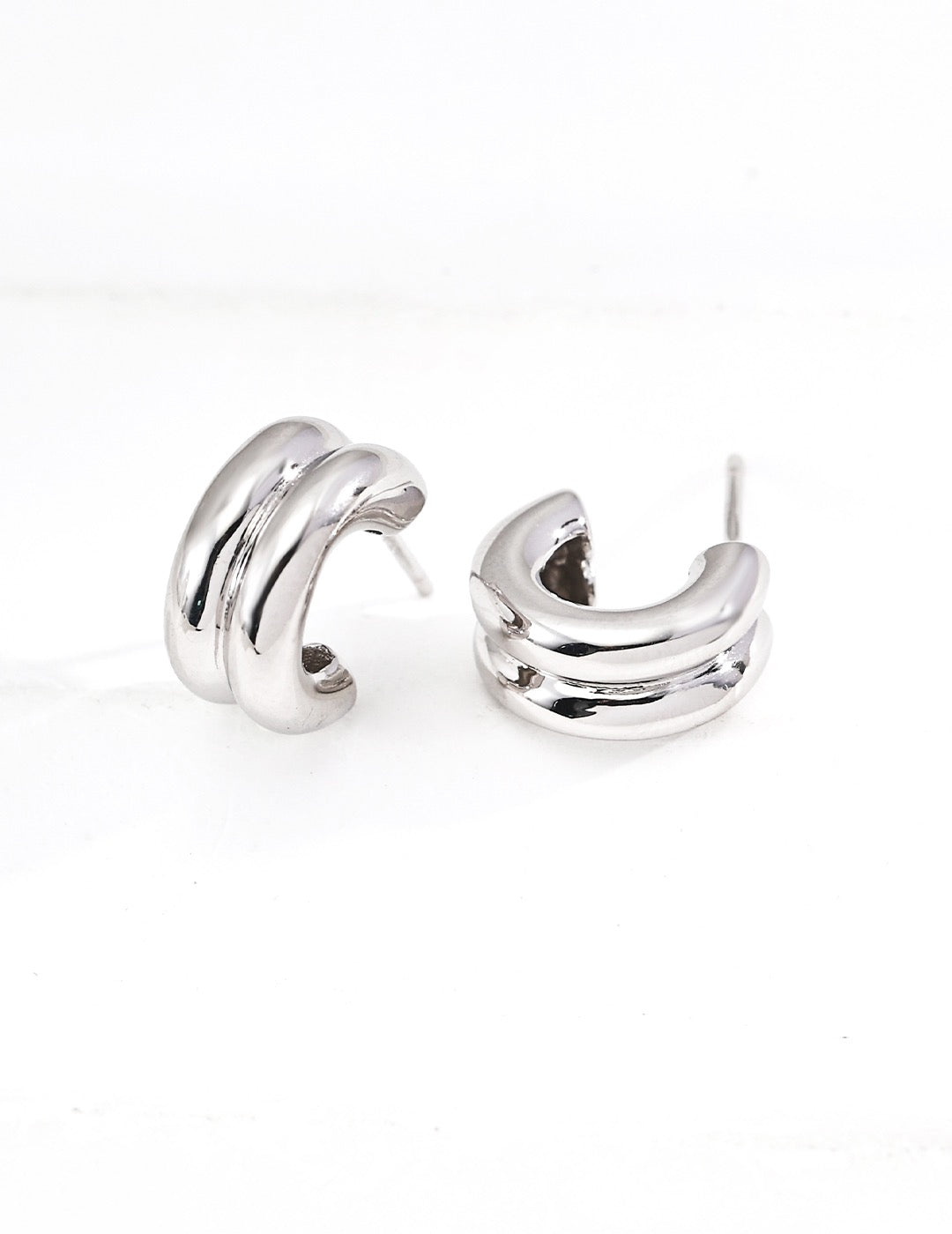 A pair of stylish silver Mezuille hoop earrings in S925 Silver with white background.