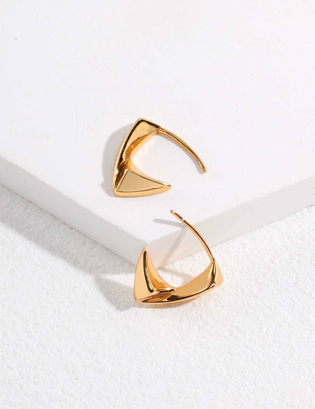 Gold plated triangular hoop earrings with a chic design.