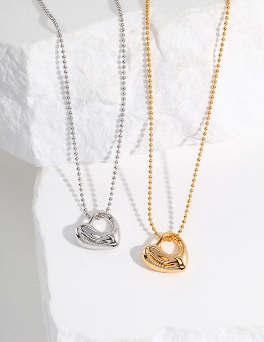 Two necklaces: one silver, one gold, both with chubby heart pendants.