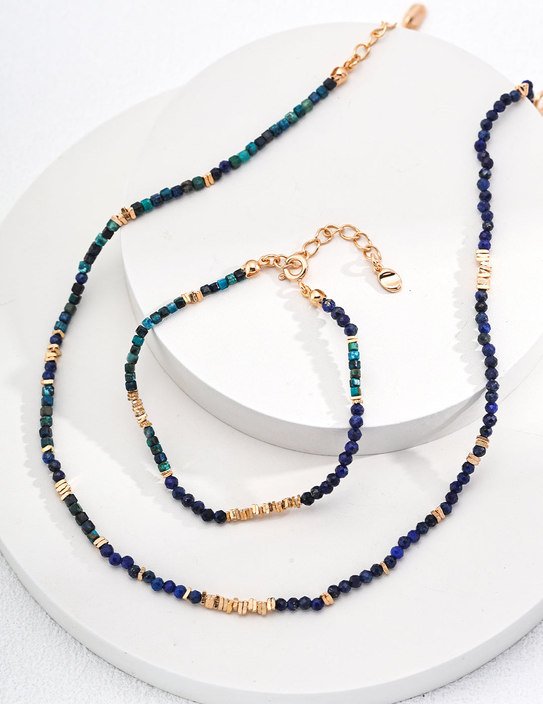 Beautiful blue and gold necklace adorned with a stylish gold chain, a perfect accessory for any occasion.