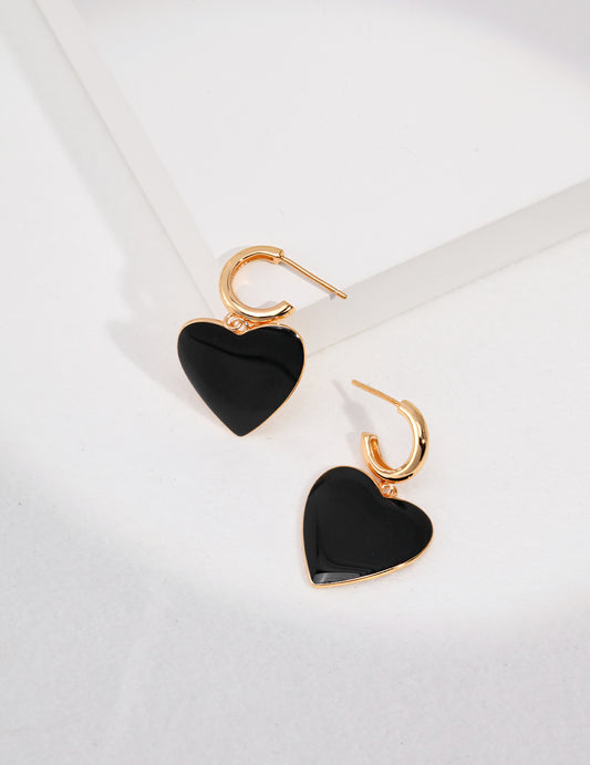 Gold plated hoop earrings, featuring black enamel hearts.