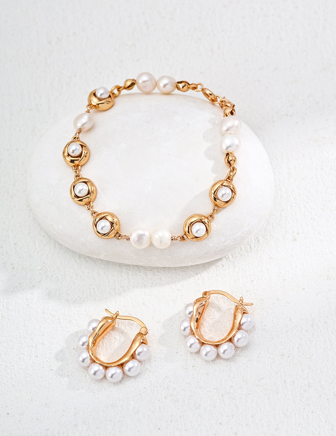 A stunning gold bracelet paired with exquisite shell pearl earrings, highlighting sophistication and classic elegance.