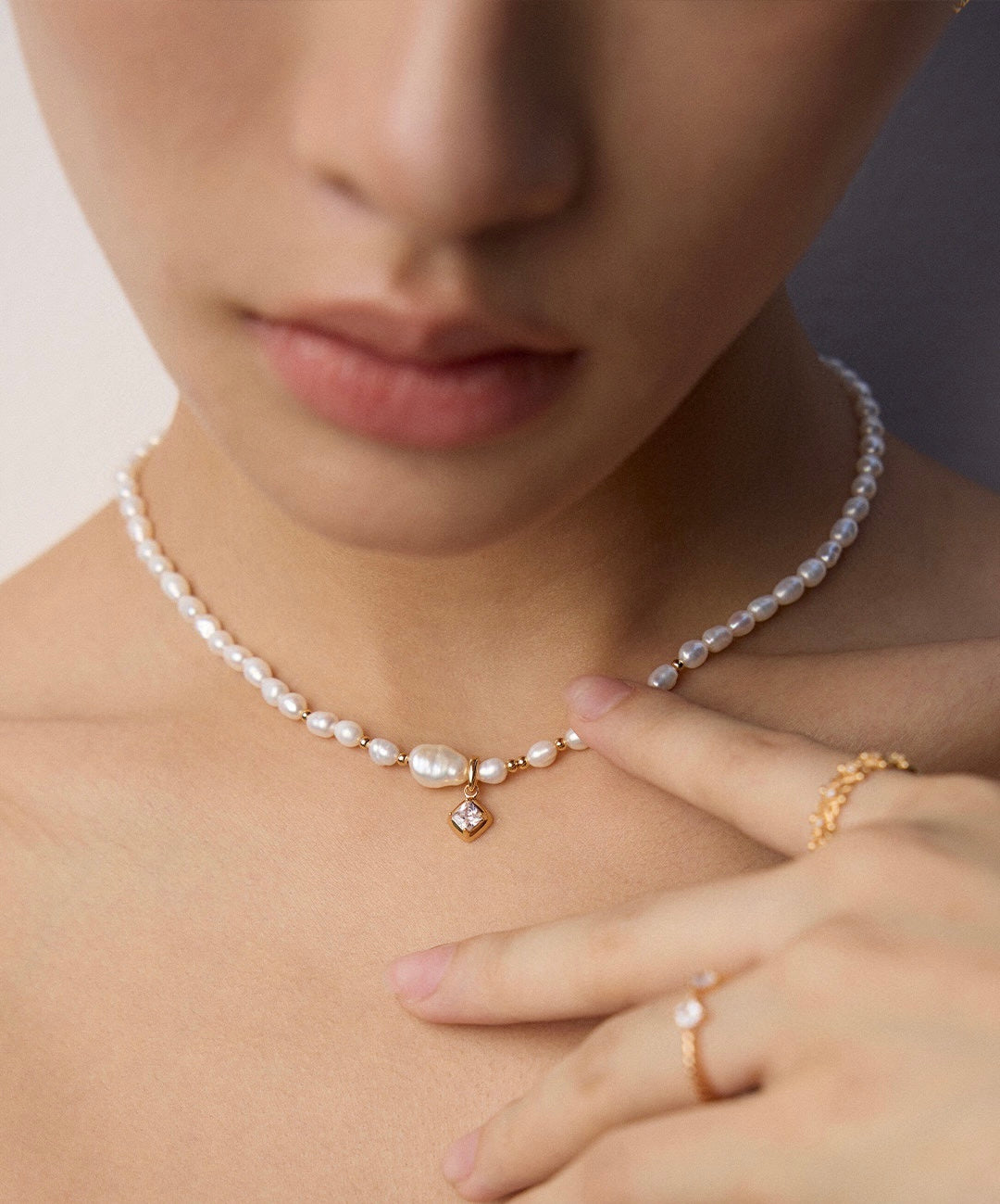 Close-up of woman wearing classy pearl necklace from Mezuille, made to be worn everyday.