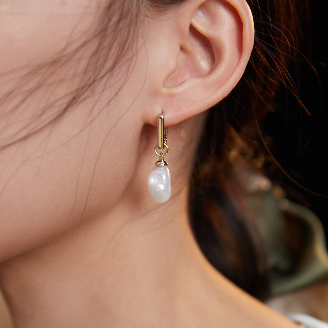 Elegant lady in baroque pearl earrings