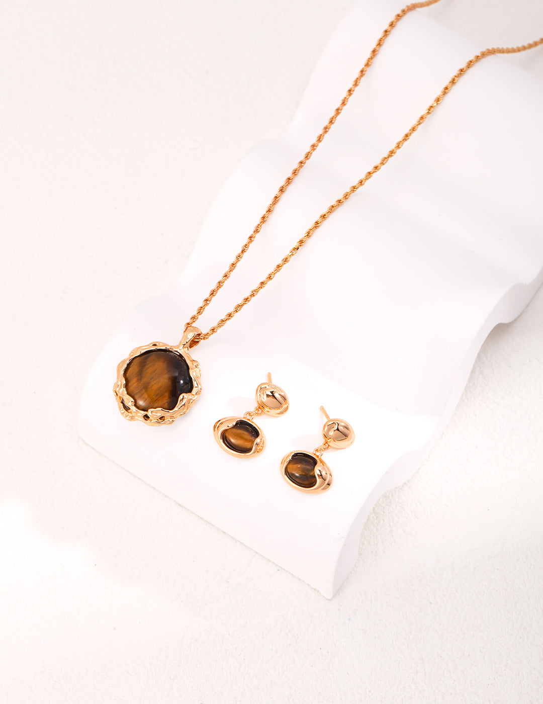 Stunning gold plated necklace and earrings set featuring a captivating tiger's eye stone.