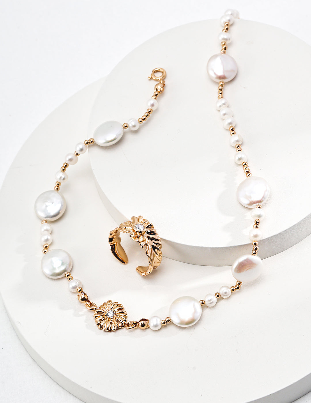 Gold necklace with pearl and ring, adorned with dainty beads and freshwater pearls in irregular sizes.