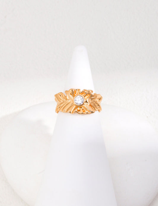 A stunning gold ring with a sparkling cubic zirconia atop, radiating elegance and sophistication.