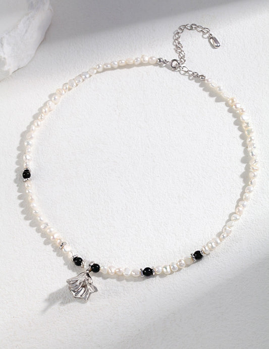 Stylish freshwater pearl and agate necklace featuring a silver charm pendant.