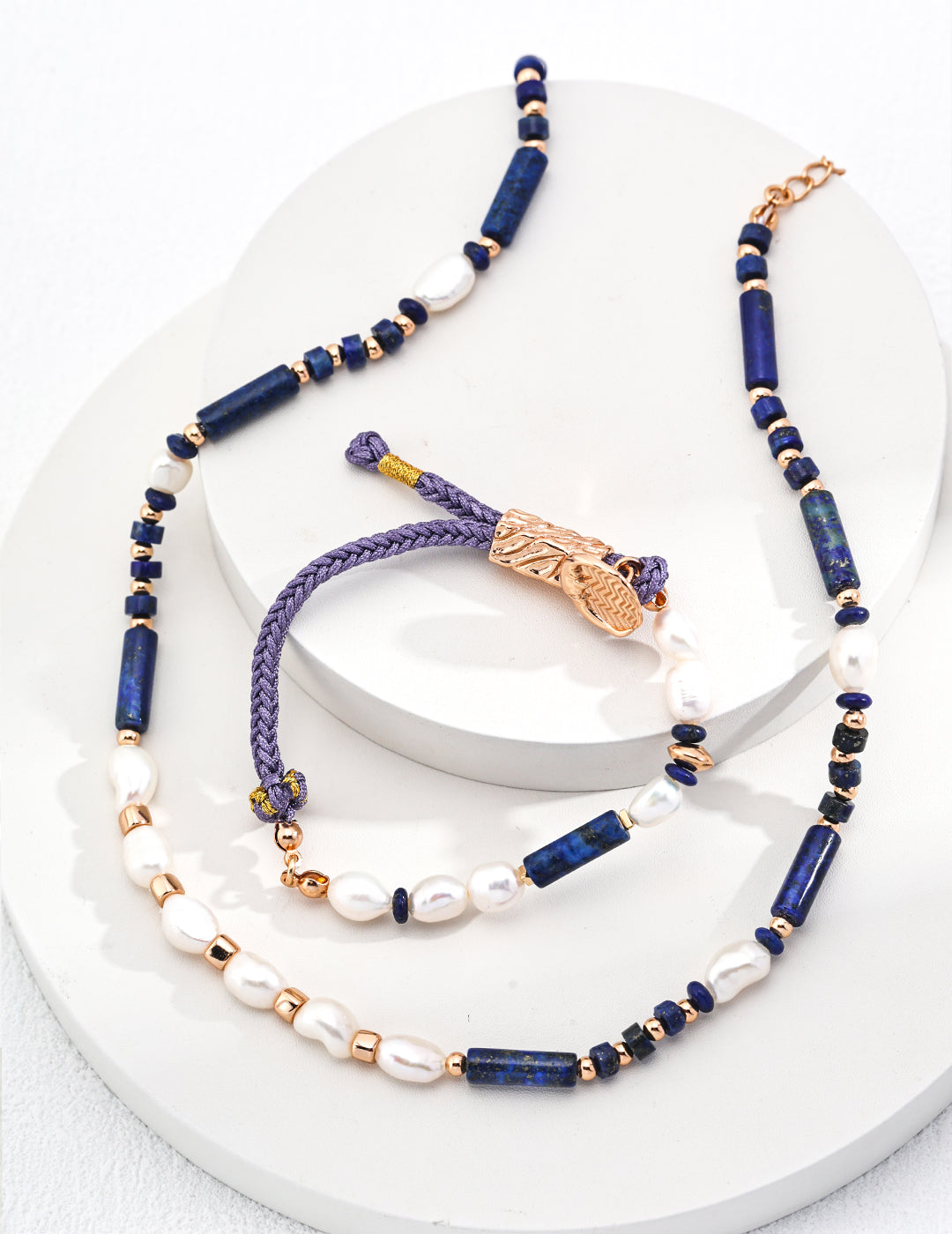 A necklace and a bracelet, both featuring lapis lazuli and pearls.