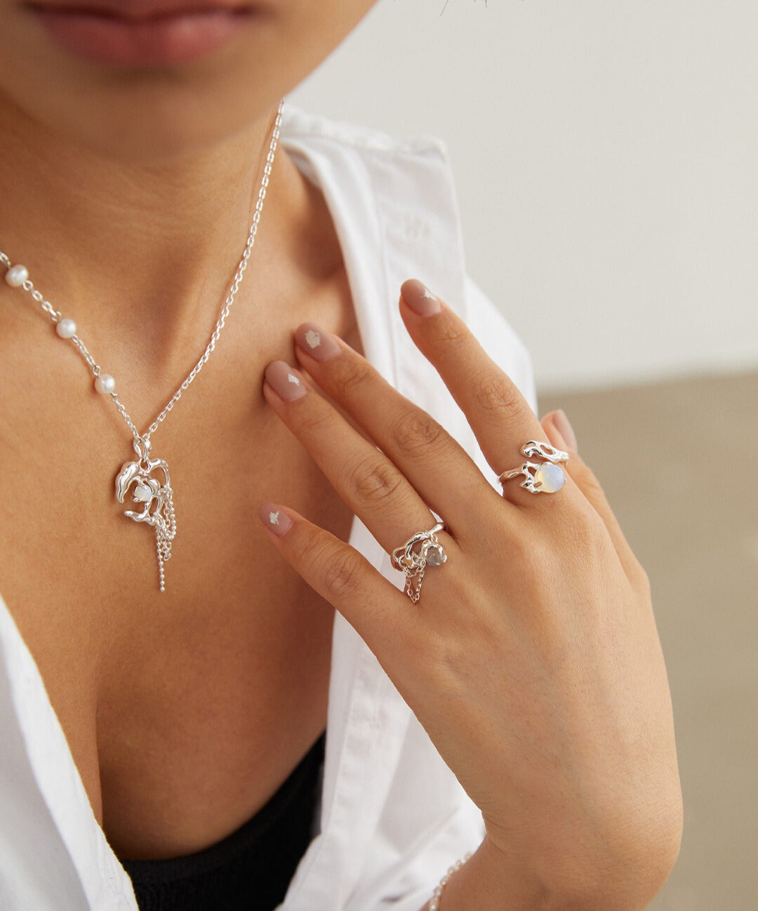 Model showcasing silver opal ring and coordinating necklace.