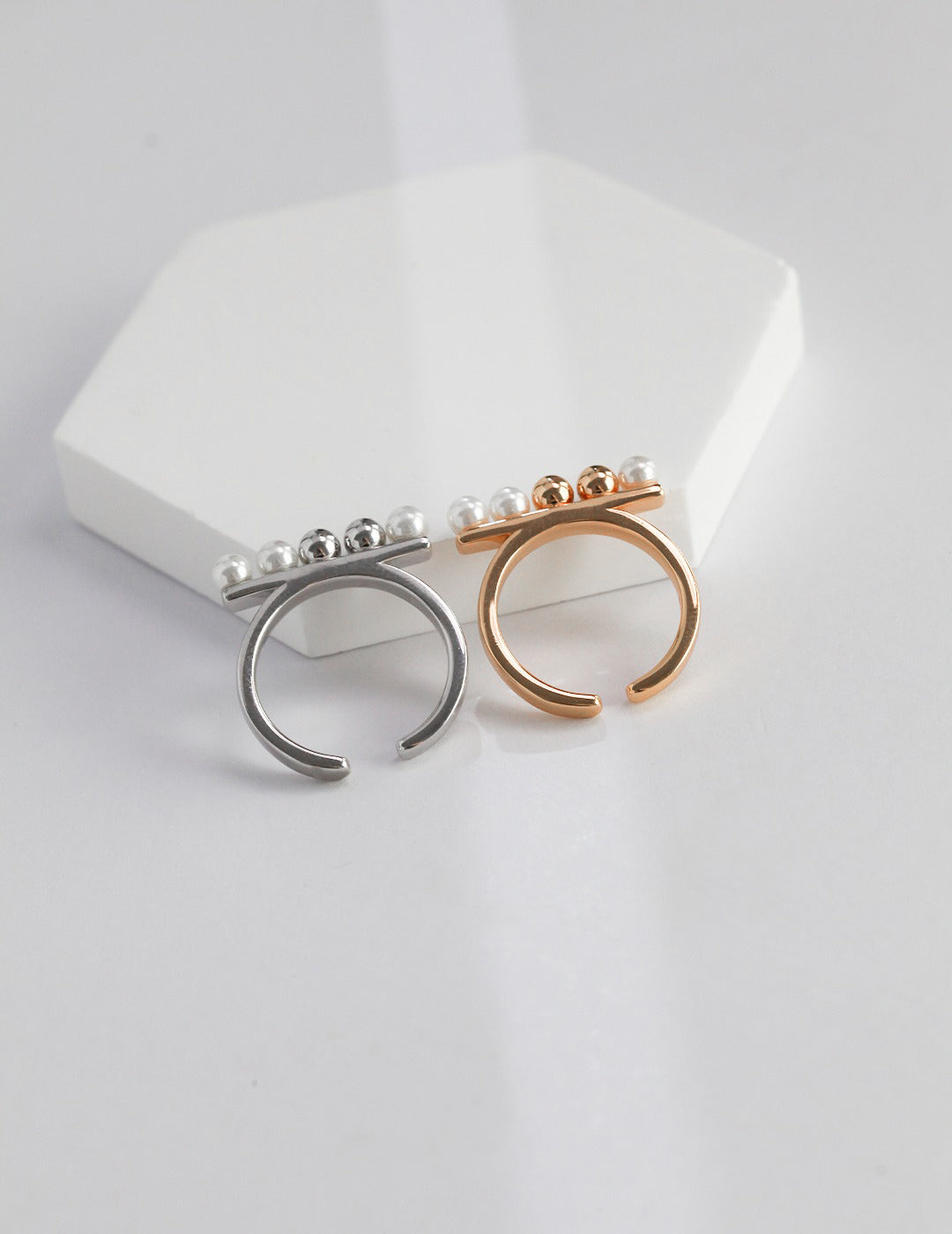 Delicate silver and gold rings featuring lustrous shell pearls and dainty beads.