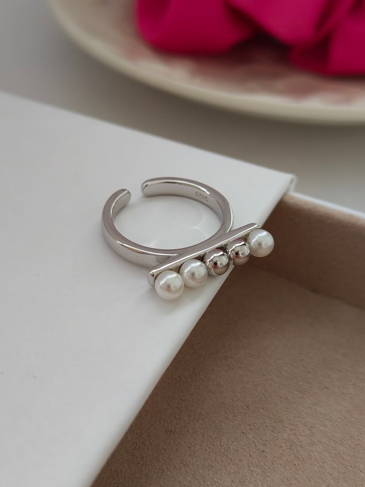 An exquisite silver ring showcasing beautiful shell pearls and intricate bead embellishments.