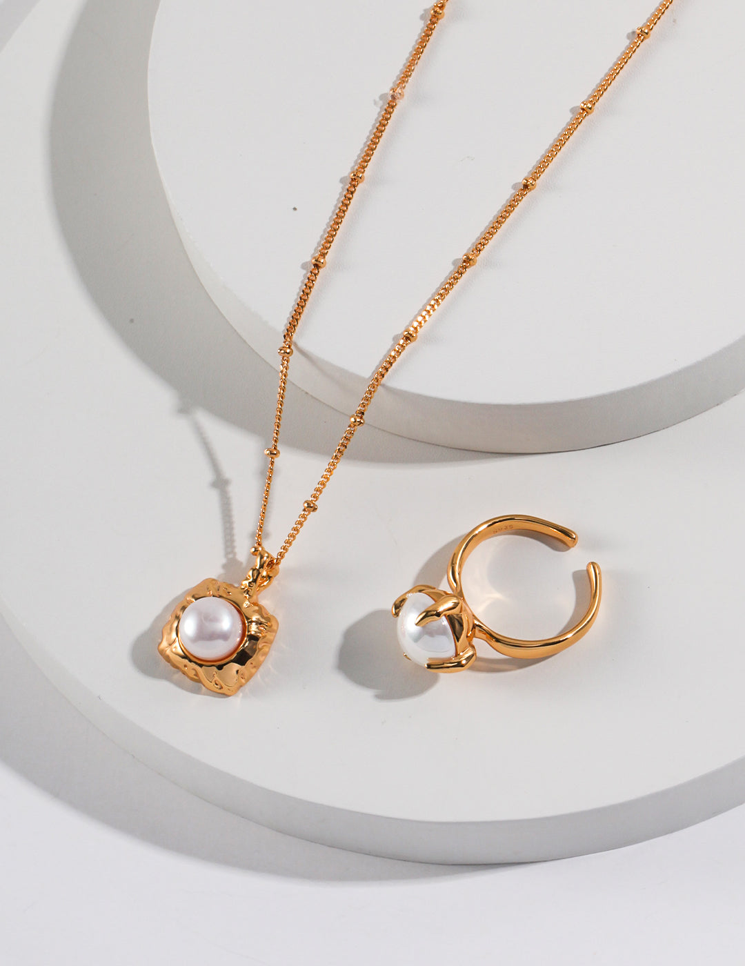 Gorgeous gold jewelry set with square freshwater pearl pendant, including necklace and ring.