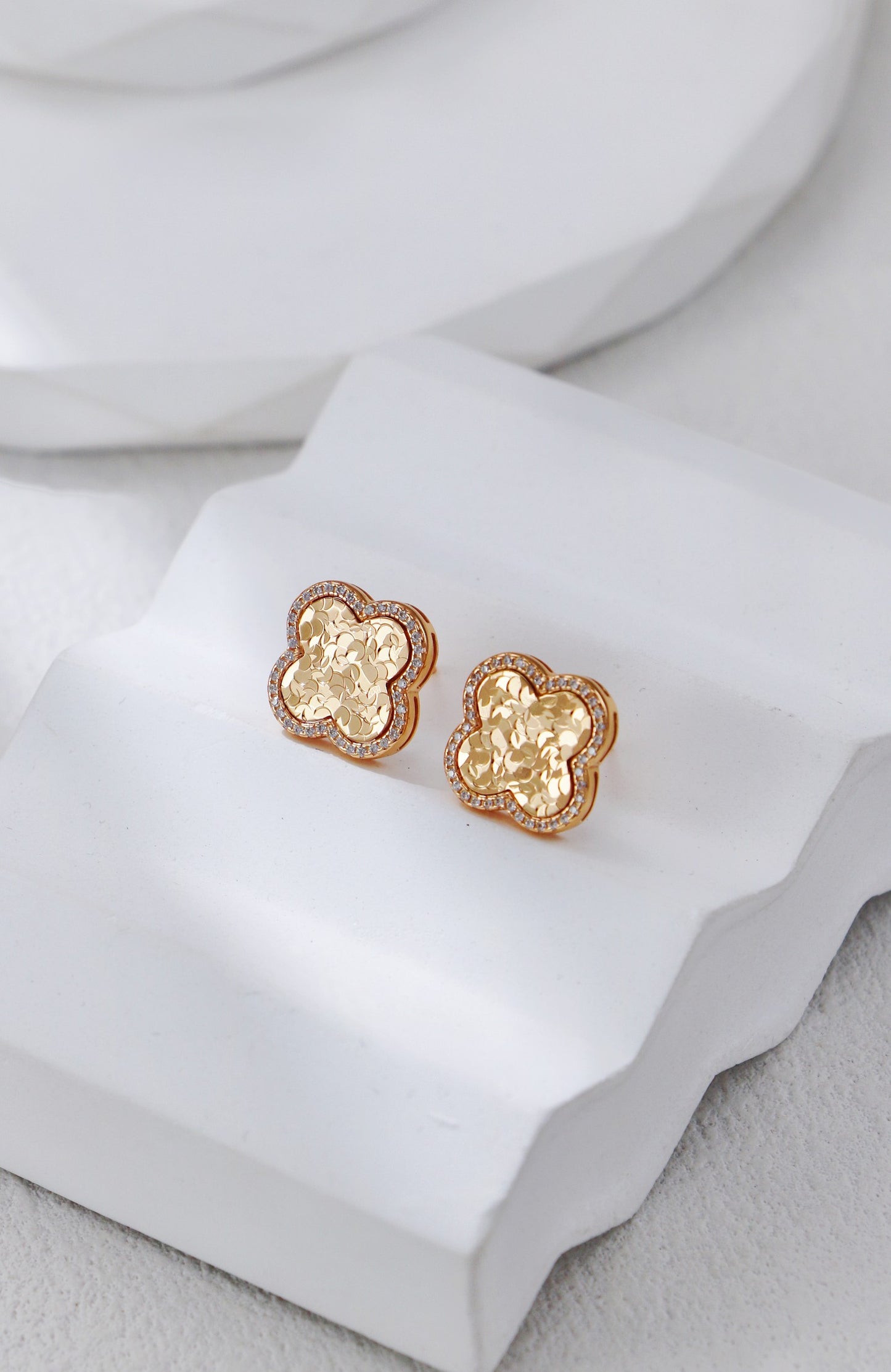 Elegant gold clover earrings with a sparkly accent, perfect for a classy and royal look.