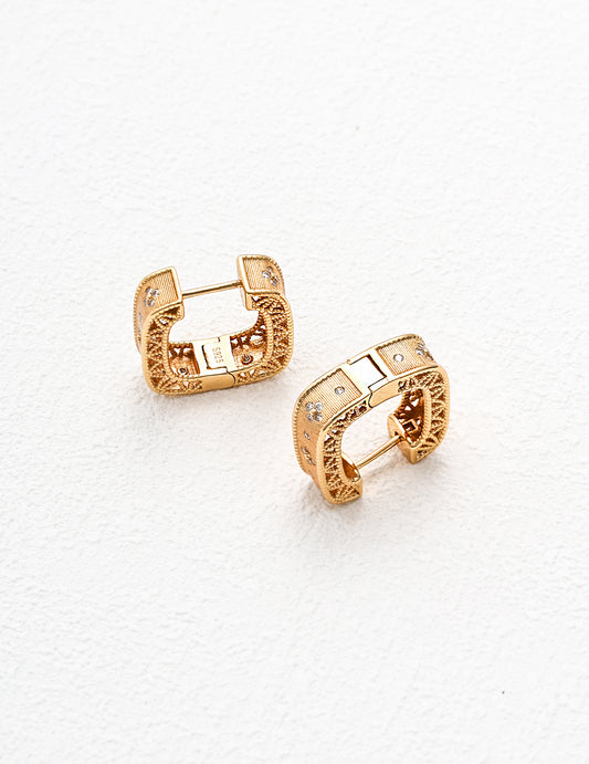 Stunning gold tone earrings embellished with cirzonia stones, offering a chic and sophisticated accessory for any occasion.