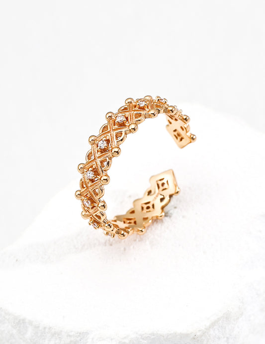 Dainty gold ring with a delicate arrangement of sparkling zirconia, exuding elegance.