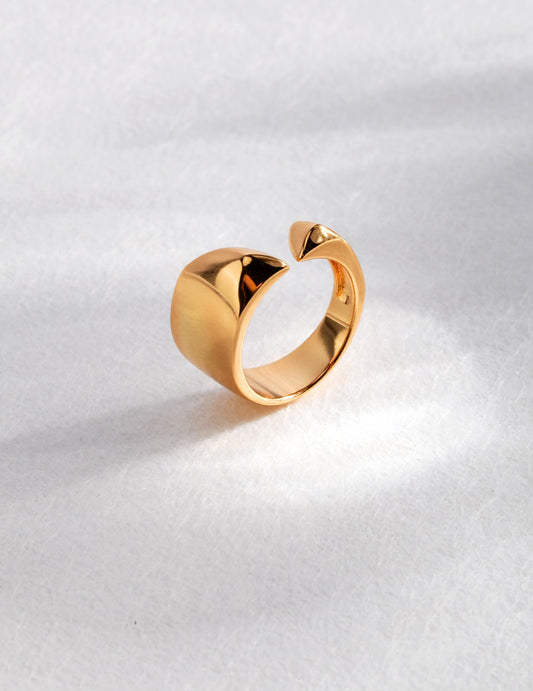 A stunning gold ring with an elegant curved shape, perfect for adding a touch of sophistication to any outfit.