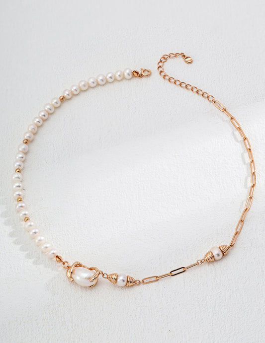 A sleek gold chain combined with a classic pearl necklace, representing modern elegance in jewelry design.