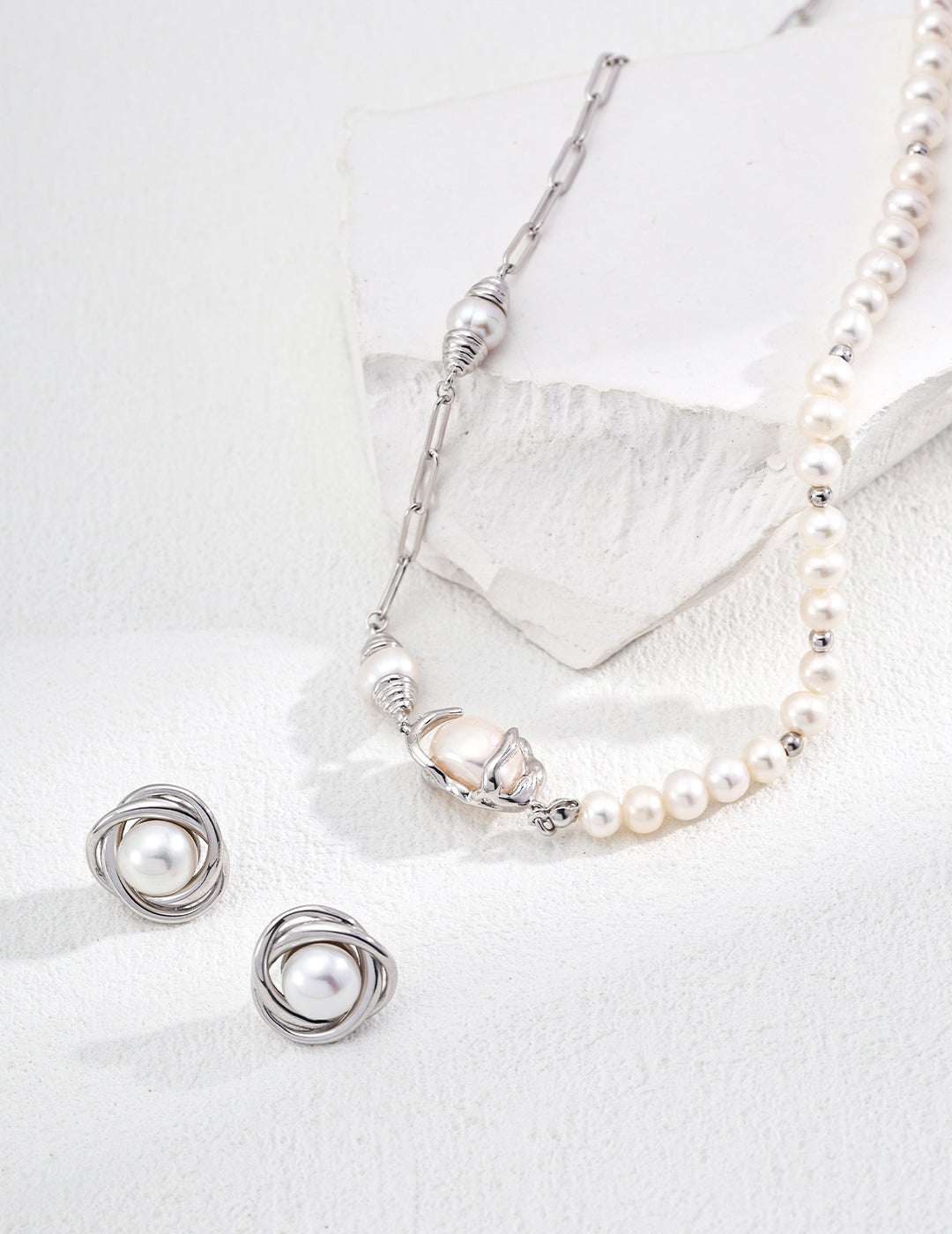 Elegant matching necklace and earrings set featuring lustrous pearls, perfect for any special occasion.