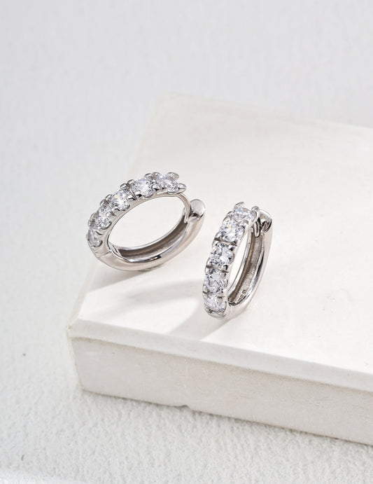 Elegant diamond hoop earrings with cubic zirconia, showcased on a sleek white box for a stunning visual appeal.