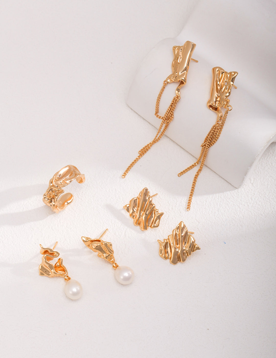 Elegant gold plated pearl earrings set with textured foil ring.