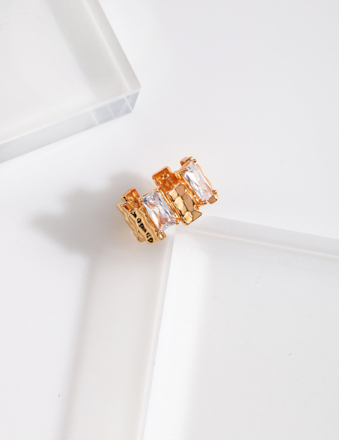 An exquisite gold with cubic zirconia stones on a pristine white surface, showcasing its timeless allure.