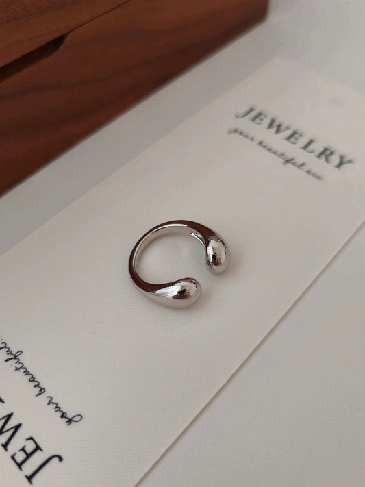 A silver chunky double dome open ring placed on top of a box.