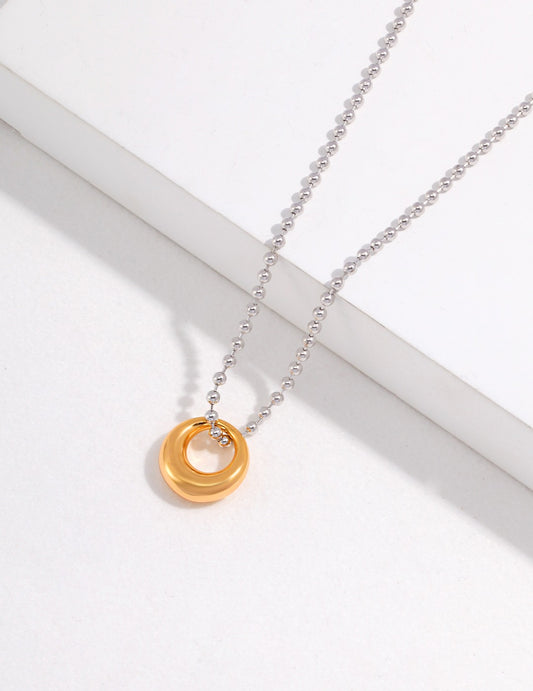 Enhance your style with a gold circle pendant on a silver ball chain, a perfect blend of elegance and simplicity.