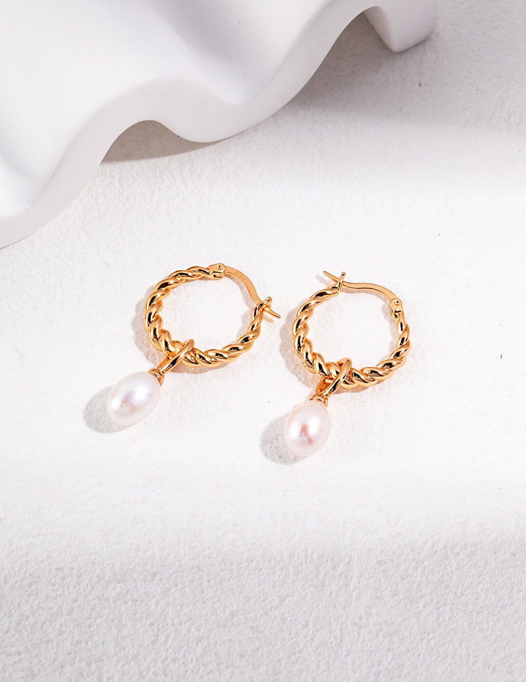 Gold plated hoop earrings with freshwater pearls.