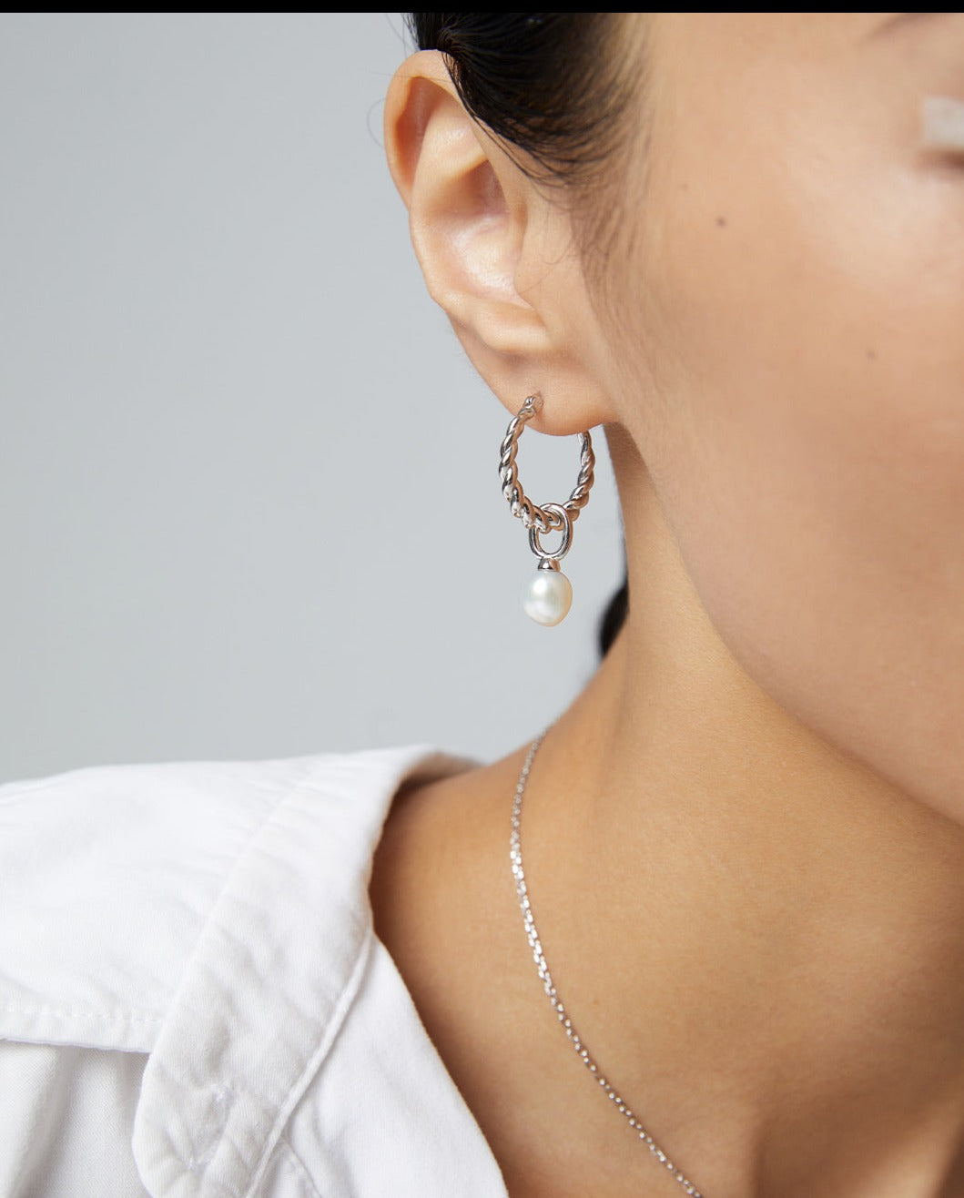 Model showcasing silver hoops and freshwater pearl hoops earrings.