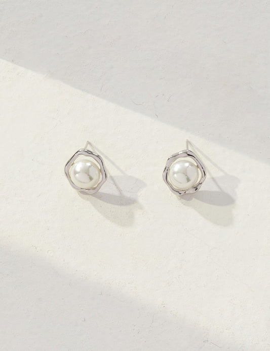 Elegant silver pearl stud earrings on a white background, showcasing a unique sunny side up design