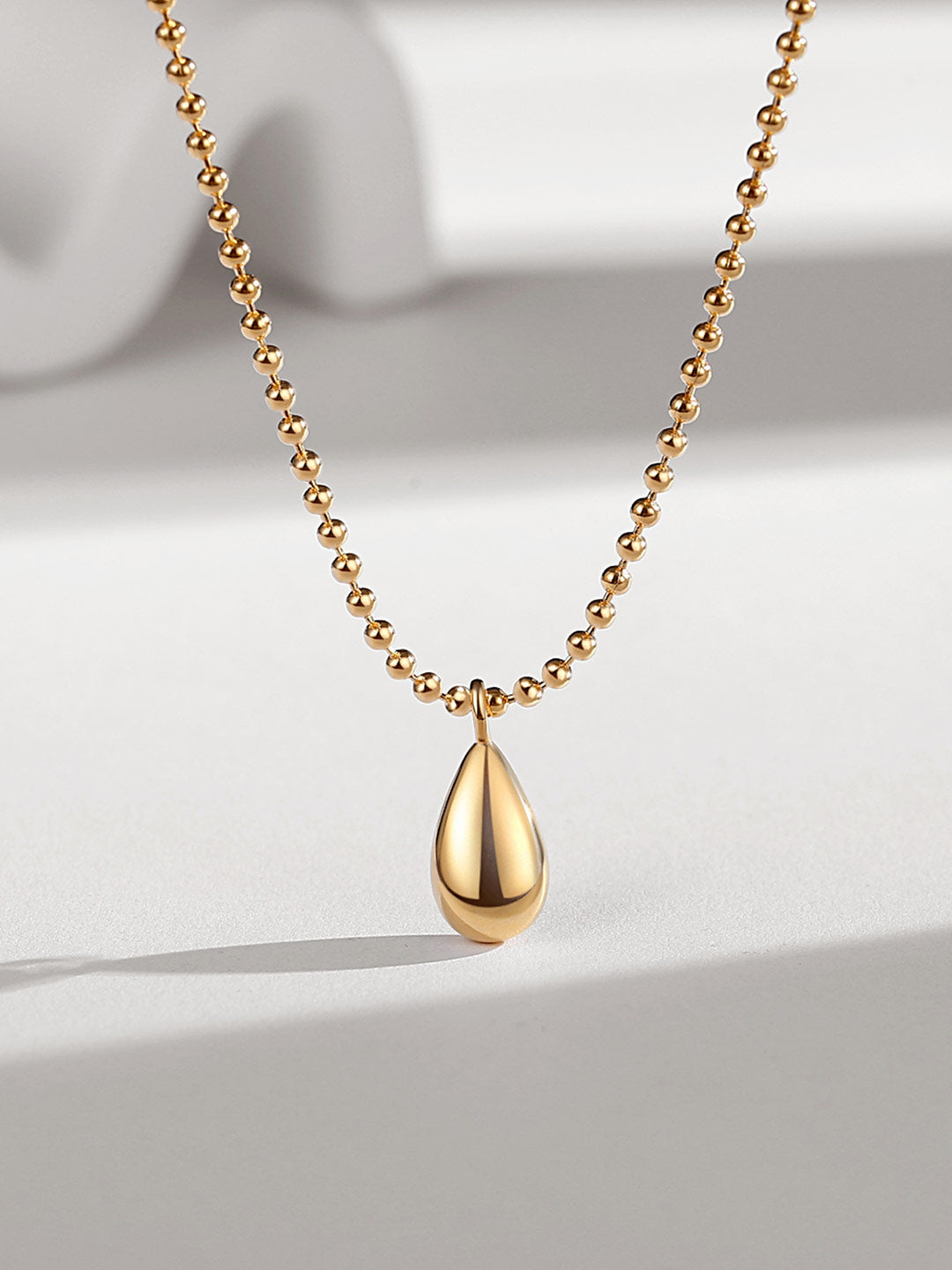 Enhance your style with a beautiful gold teardrop pendant necklace, a timeless accessory.