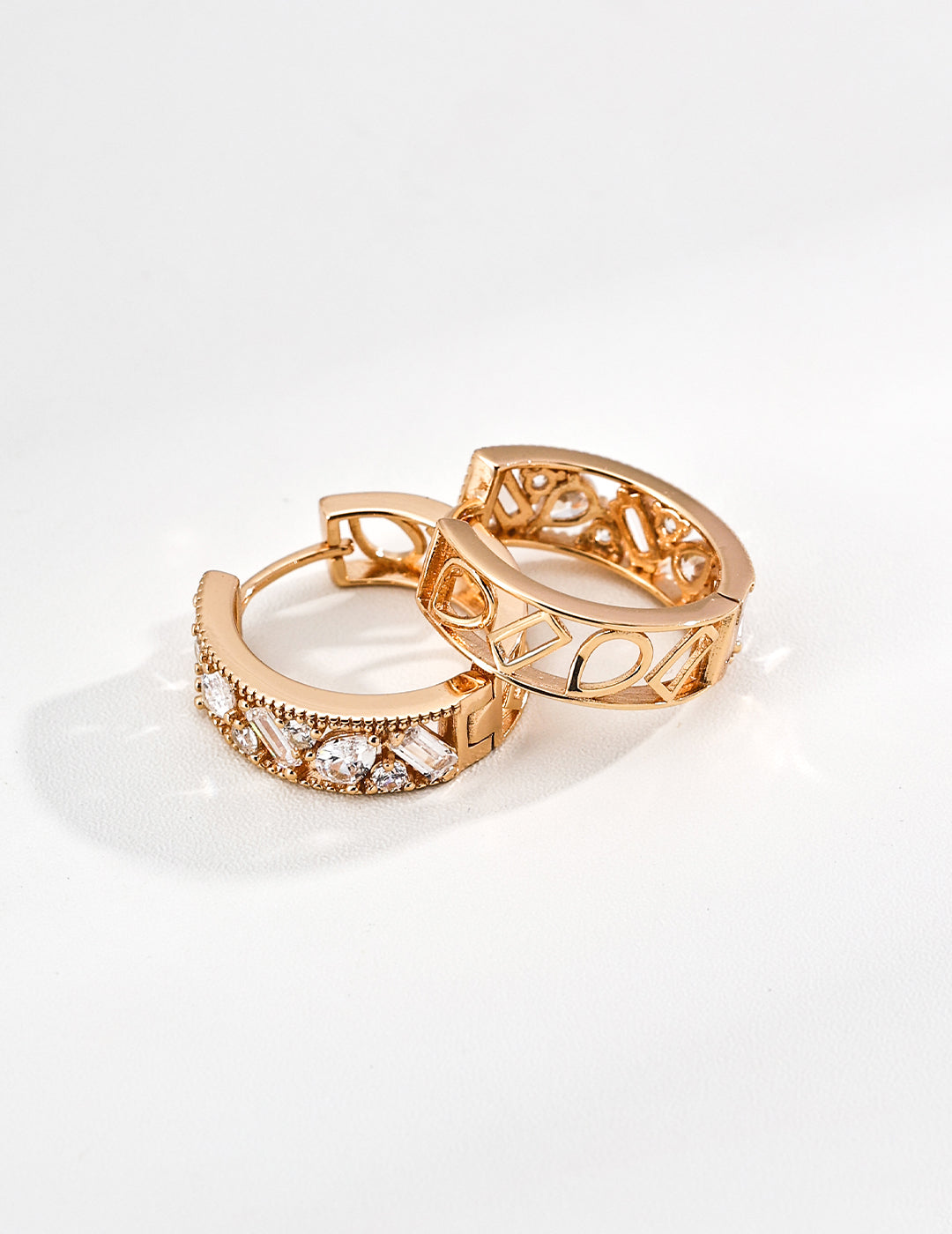 A close-up product photograph of the 18K gold-plated Edith hoops, highlighting their geometric cutout design and sparkling pave-set cubic zirconia stones.