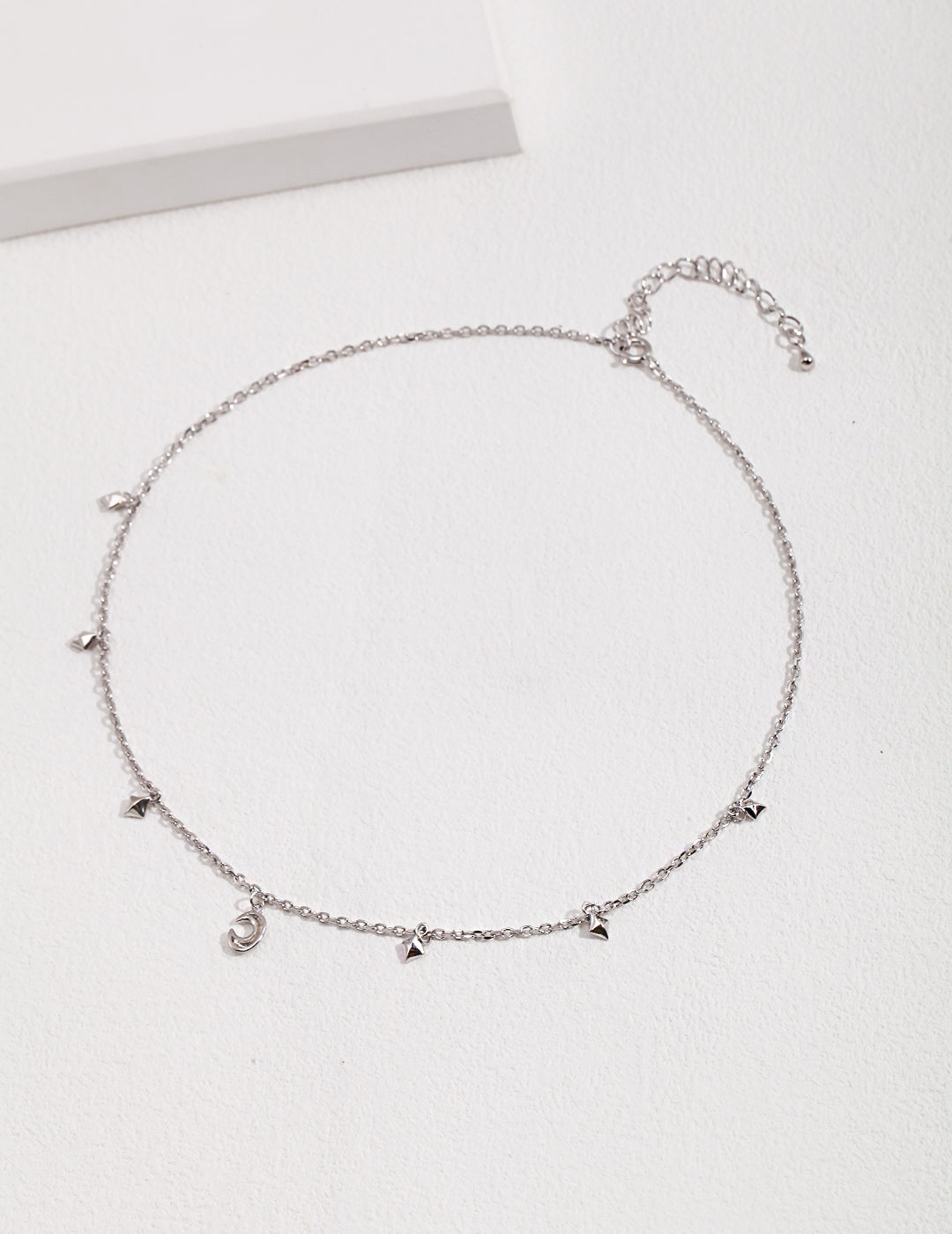 Silver necklace with small celestial charms.