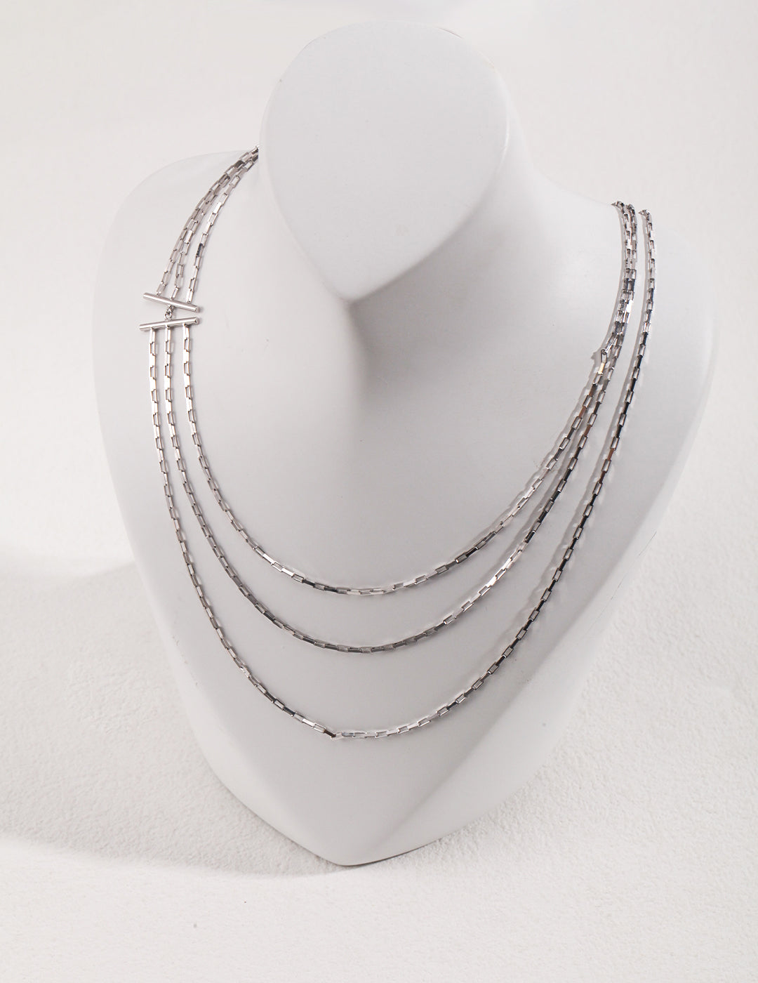 Triple-strand silver chain necklace for a chic look.