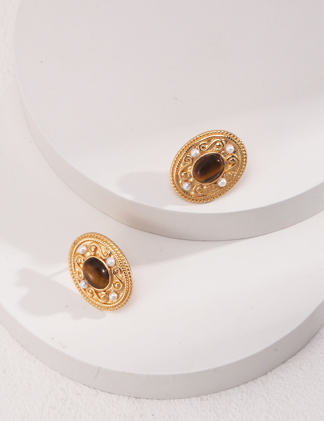 Stunning gold plated tiger's eye earrings with pearls, highlighting two gold tone earrings with a brown stone.