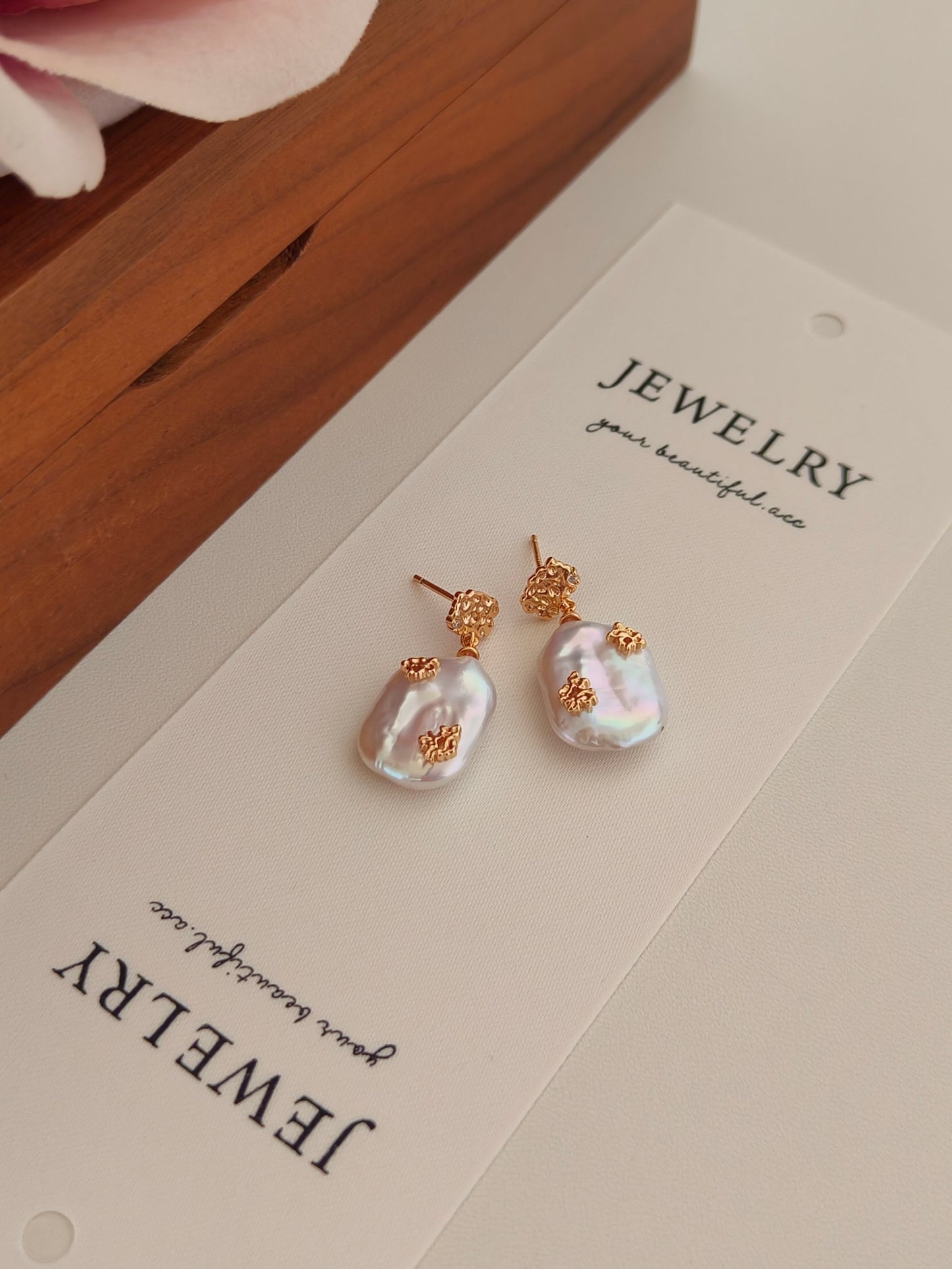 Gorgeous pair of gold pearl drop earrings by Mezuille, on jewelry card.