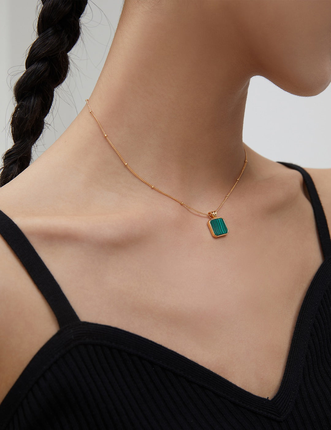 Gold plated necklace with malachite pendant, an elegant jewelry piece. 